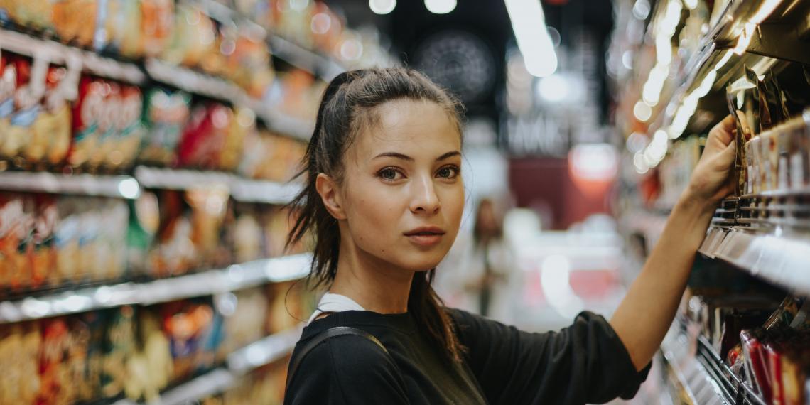 Woman in supermarket aisle