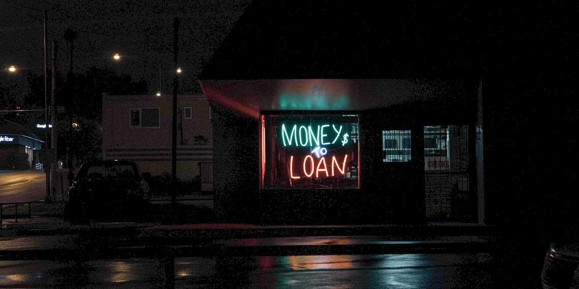 Neon sign showing "Money to Loan"